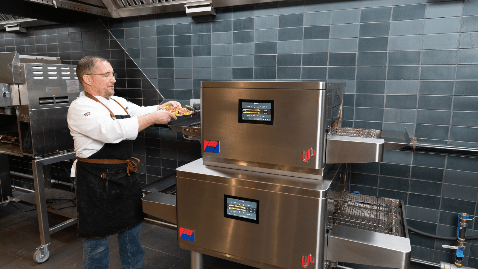 Chef taking food out of Middleby Marshall oven